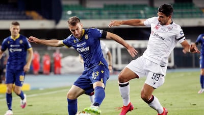 Verona's Alan Empereur (33) battles Cagliari's Giovanni Simeone (99). AP Photo