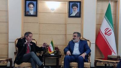 Iranian spokesman Behrouz Kamalvandi meets IAEA chief Rafael Mariano Grossi, left, at Mehr Abad airport in Tehran. EPA