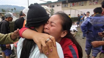 A woman cries after identifying a relative who was one of the flash flood victims after Typhoon Bopha. Reuters / Karlos Manlupig