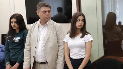 Maria (L) and Angelina (R), two of the three Khachaturyan teen sisters charged with their father's murder attend a hearing at Moscow's Basmanny District Court. TASS