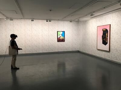 A visitor trying on the VR headset for Shezad Dawood’s Encroachments (2019).