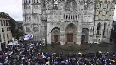 Mourners gather in the rain outside Rouen cathedral on August 2, 2016, during a funeral service in memory of Father Jacques Hamel who was killed last week by attackers pledging allegiance to ISIL. Jacky Naegelen/Reuters