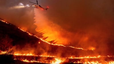 Water is dropped by helicopter on the Kenneth Fire in the West Hills section of Los Angeles. AP Photo