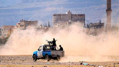 Yemeni men stand at the back of an armed pick in the capital Sanaa on December 19, 2018.