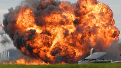 September 17, 2001: A single engine T-28 from the six-plane Trojan Horsemen Demonstration Flight Team crashes and explodes during a performance at the Thunder Over the Blue Ridge Open House and Air Show. AP Photo/Journal Newspaper, Ron Agnir

