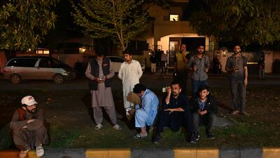 People gather outside a mall in Islamabad after the earthquake, which was felt in Pakistan, Afghanistan and parts of India. AFP