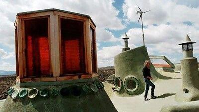 The American architect Michael Reynolds has designed what he calls the ultimate green homes built entirely from recycled garbage. Eric Draper / AP Photo