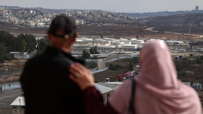 Relatives of a detained Palestinian look at a military prison in the Israeli-occupied West Bank. AFP