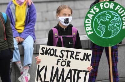 Swedish climate activist Greta Thunberg holds a poster reading ‘School strike for Climate’ as she protests in front of the Parliament Riksdagen, Sweden, on Friday, September 4 2020. EPA