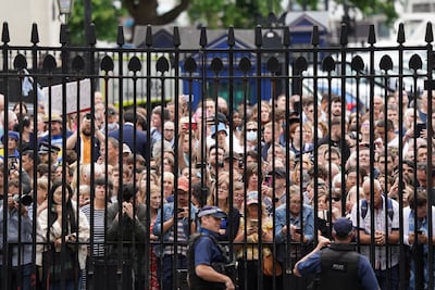 Members of the public stand outside the gates of Downing Street as Prime Minister Boris Johnson reads his resignation statement. PA