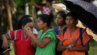 A group of Ngabe-Bugle women take photos. AP