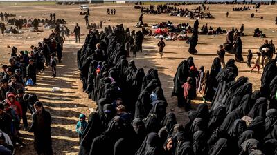 Civilians evacuated from ISIS's embattled holdout of Baghouz in Syria wait at a screening area held by the US-backed Kurdish-led Syrian Democratic Forces. AFP