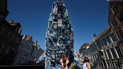 Tourists take pictures the installation in Bruges. John Thys / AFP