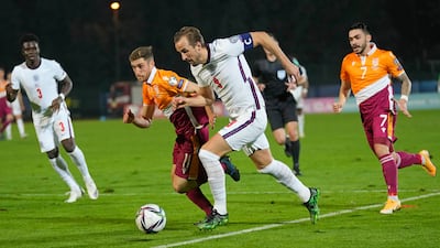 England's Harry Kane runs with the ball. AP Photo