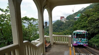 A Peak Tram passes an uphill of the Victoria Peak in Hong Kong on June 17, 2021. Vincent Yu / AP Photo