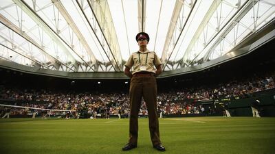 A general view of a security guard on Centre Court as the roof is closed so play can continue during Rafael Nadal's match against Mikhail Kukushkin on Saturday. Nadal won in four sets. Matthew Stockman / Getty Images