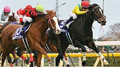 Vodka, right, crosses the finish line of the Japan Cup yesterday a nose ahead of Oken Bruce Lee.
