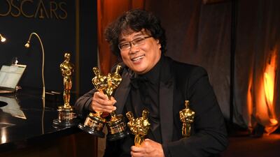 Bong Joon-ho holds the Oscars for best original screenplay, best international feature film, best directing, and best picture for "Parasite" at the Governors Ball after the Oscars on Sunday, February 9, 2020, at the Dolby Theatre in Los Angeles. AP