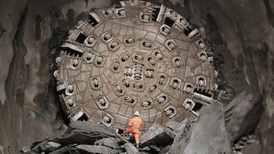 A miner looking at the tunnel drilling machine ‘Sissi’ after it broke through the last section of the Gotthard Base Tunnel in 2010. The opening celebrations of the Switzerland’s the largest-ever construction project will start on June 1. Arno Balzarini / EPA