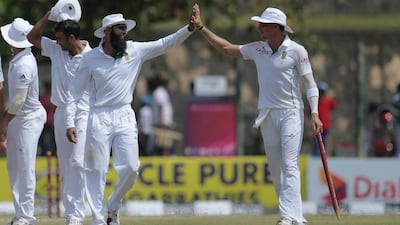 Hashim Amla and Dale Steyn of South Africa high-five after their victory in the first Test against Sri Lanka on Sunday. Eranga Jayawardena / AP / July 20, 2014