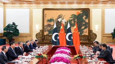 China's President Xi Jinping (2nd L) listens to Pakistan's Prime Minister Imran Khan (R) during their meeting at the Great Hall of the People in Beijing. AFP