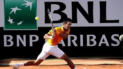 Novak Djokovic returns a shot to Nicolas Almagro on Tuesday during his second round victory at the Rome Masters. Claudio Onorati / EPA / May 12, 2015
