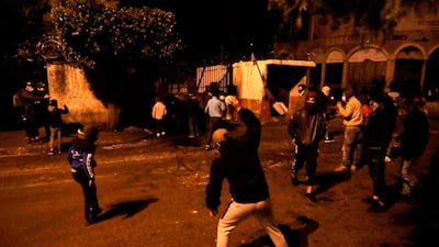 Lebanese anti-government protesters hurl rocks at the municipality building in the northern city of Tripoli. AFP