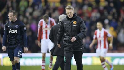 United manager David Moyes alongside Wayne Rooney after the 2-1 Premier League defeat at Stoke City in February 2014. Getty