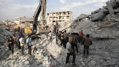 Syrians gather in Zardana, in the mostly rebel-held northern Syrian Idlib province, in the aftermath of following air strikes in the area late on June 8, 2018. Omar Haj Kadour / AFP