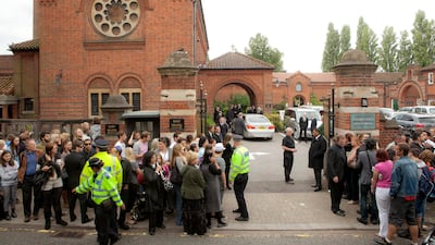Members of the public gather opposite Golders Green Crematorium, north London. AP