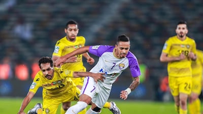 Al Wasl, in yellow, in action against Al Ain during their President's Cup final at Zayed Sports City Stadium on Thursday. Victor Besa / The National