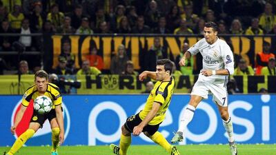 Real Madrid’s Cristiano Ronaldo, right, scores the opener against Borussia Dortmund players Sokratis Papastathopoulos, centre, and Matthias Ginter, left. Ina Fassbender / EPA