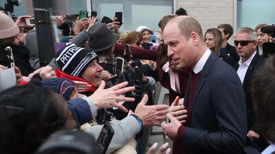Prince William takes time to greet people in the crowd after a visit to Roca. AFP