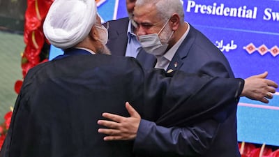 The leader of the Palestinian Hamas movement, Ismail Haniyeh shakes hands with Iran's outgoing president Hassan Rouhani.