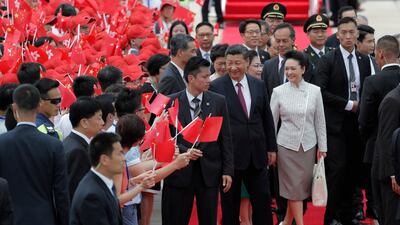 Chinese President Xi Jinping, centre right, and wife Peng Liyuan greeted on their arrival in Hong Kong by supporters waving red Hong Kong and Chinese flags on Thursday, June 29, 2017.The visit is to mark 20 years since China took control in the former British colony.Kin Cheun / Associated Press