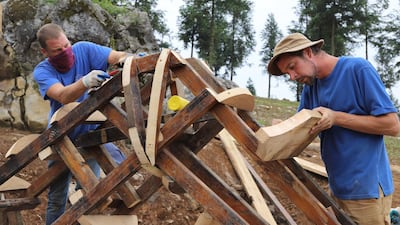 Thomas Dambo, right, working on his wooden sculptures.
