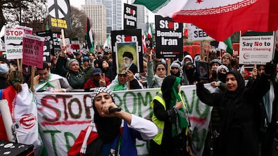 Anti-war activists hold signs and images of Iran's late supreme leader Ayatollah Ali Khamenei at a protest outside the US embassy in London. Reuters