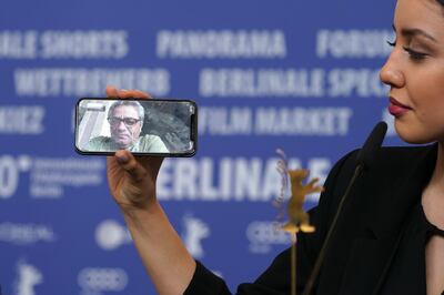 Baran Rasoulof phones Iranian director Mohammad Rasoulof, winner of the Golden Bear for Best Film for 'There Is No Evil' at the award winners press conference during the 70th Berlinale International Film Festival in Berlin, Germany. Getty Images