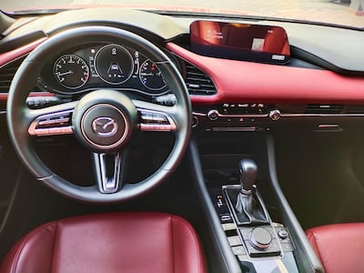 The red-and-black cabin boasts stitched leather trim. Gautam Sharma / The National