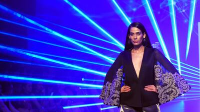 Pankaj & Nidhi pair long sleeves with short skirts in this look. AFP