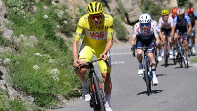 UAE Team Emirates' Slovenian rider Tadej Pogacar, wearing the overall leader's yellow jersey, cycles ahead of Team Visma - Lease a Bike team's Danish rider Jonas Vingegaard. AFP