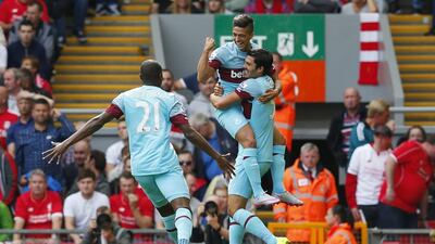 Manuel Lanzini celebrates with teammates after scoring the first goal for West Ham against Liverpool on Saturday. Eddie Keogh / Reuters