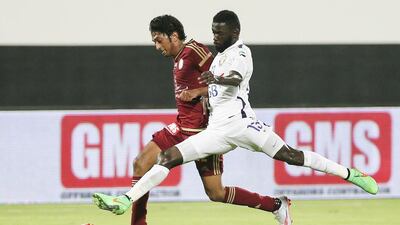 Al Whada’s Amer Omar, left, vies with Ahmed Barman of Al Ain on Friday night in Abu Dhabi. Sarah Dea / The National