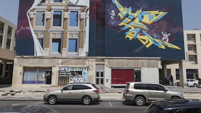 24 murals have been painted on the side of 12 apartment buildings and shops around the Karama shopping complex. Antonie Robertson / The National