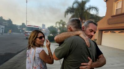 Homeowners comfort each other in Anaheim Hills. Paul Buck / EPA