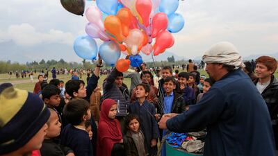 Afghan children buy balloons as they celebrate in anticipation of the U.S-Taliban agreement to allow a U.S. troop reduction and a permanent ceasefire, in Jalalabad, Afghanistan. REUTERS