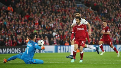 Liverpool's Mohamed Salah scores his sides second goal past Roma's Alisson Becker. Clive Brunskill / Getty Images