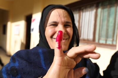 An Egyptian woman shows her ink-marked finger after voting at a polling station in the presidential election in Cairo. EPA