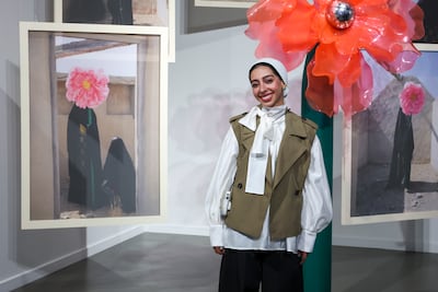 Khadija Hamid with Where We Bloom Unseen, a multimedia work that uses floral symbolism to explore identity, memory and heritage. Victor Besa / The National