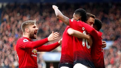 Rashford celebrates scoring United's goal with Shaw and teammates. Reuters